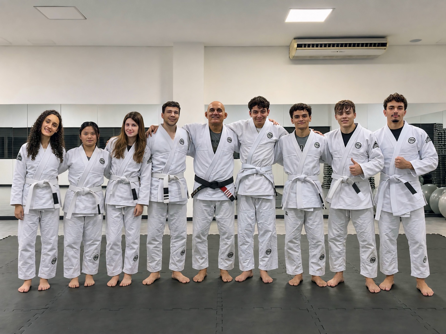 Equipe Lorian Jiu-Jítsu reunida no dojo, com Elias Filho e o professor Carlos Gross Jr. ao centro
